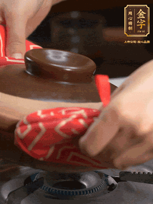 中火調成小火，鋪上香腸蓋蓋燜5分鐘。不斷轉動瓦煲，讓側壁的飯形成飯焦